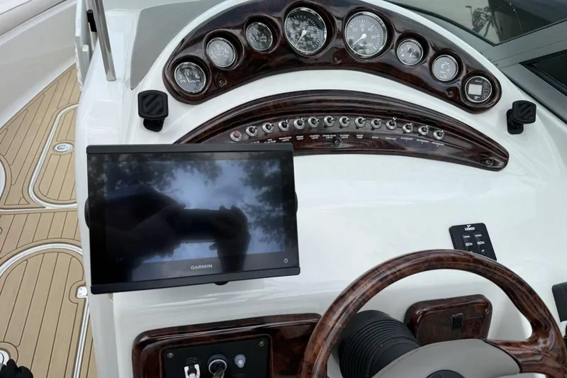 Slide: The Image of Dashboard of a 2005 Crownline 288 BR boat with Garmin display and gauges. - 9