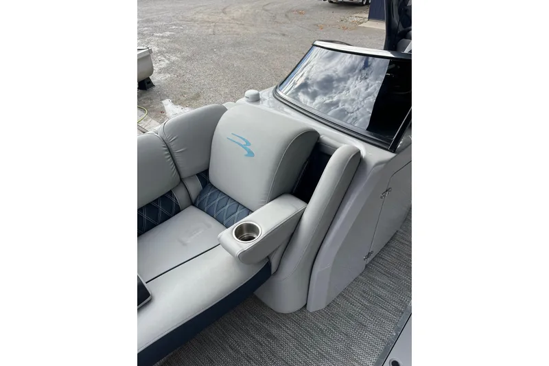 Slide: The Image of 2021 Bennington 27 QXFBWAX2 boat interior with plush seating and cup holder. - 12