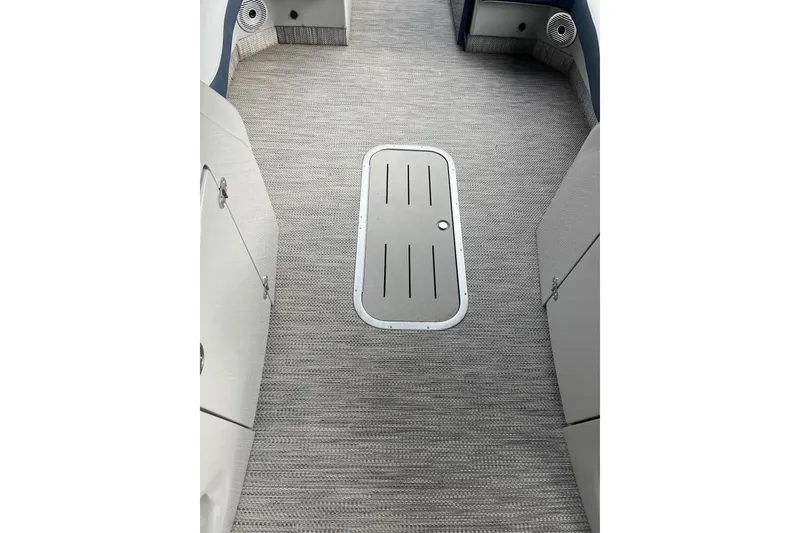 Slide: The Image of 2021 Bennington 27 QXFBWAX2 boat interior with carpeted flooring and storage hatch. - 13