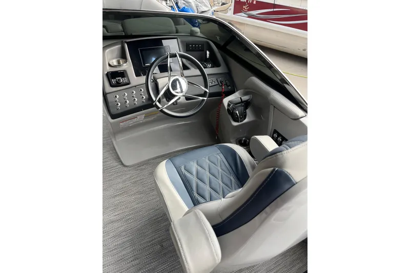Slide: The Image of 2021 Bennington 27 QXFBWAX2 boat helm with steering wheel and control panel. - 15