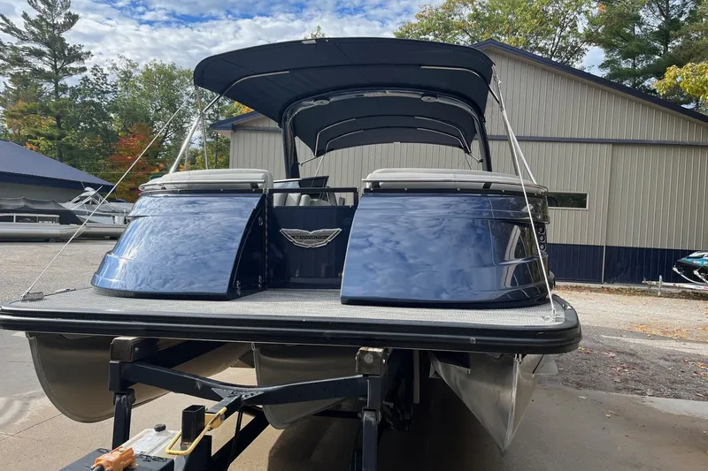 Slide: The Image of 2021 Bennington 27 QXFBWAX2 pontoon boat with canopy, parked outdoors. - 20