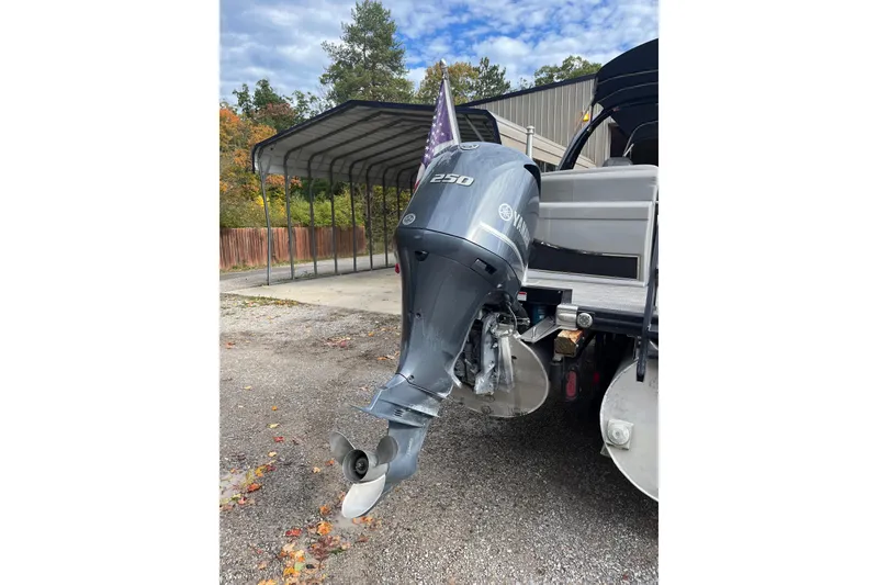 Slide: The Image of 2021 Bennington 27 QXFBWAX2 with Yamaha 250 outboard motor, parked outdoors. - 22