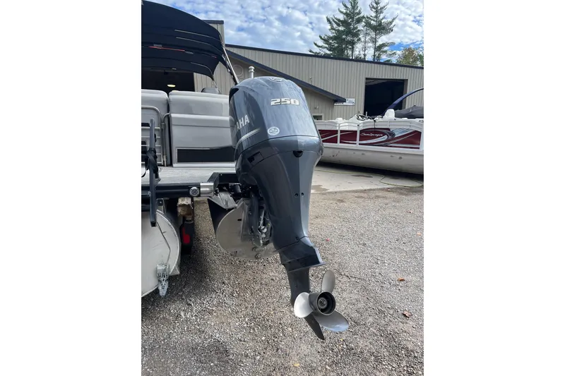 Slide: The Image of 2021 Bennington 27 QXFBWAX2 with Yamaha 250 outboard motor in a boatyard. - 23