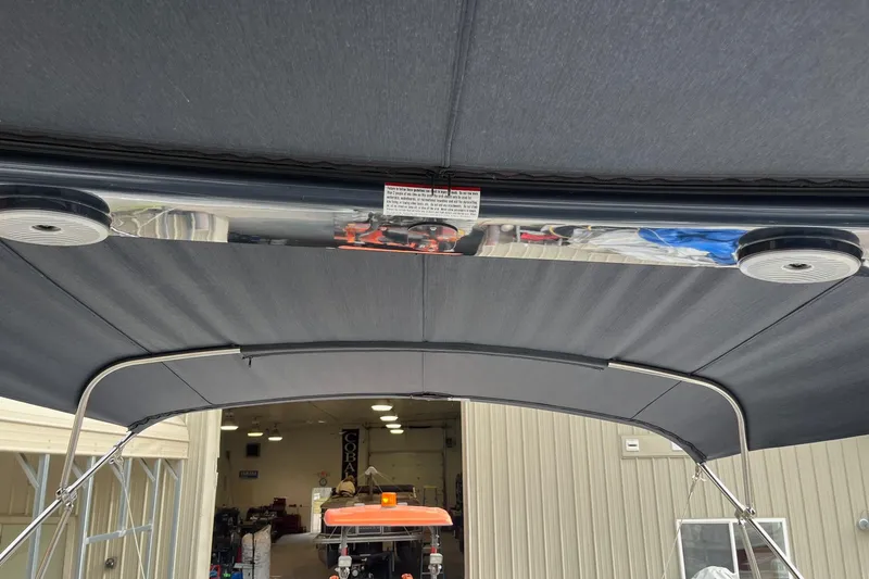 Slide: The Image of 2021 Bennington 27 QXFBWAX2 boat canopy in a workshop setting. - 3