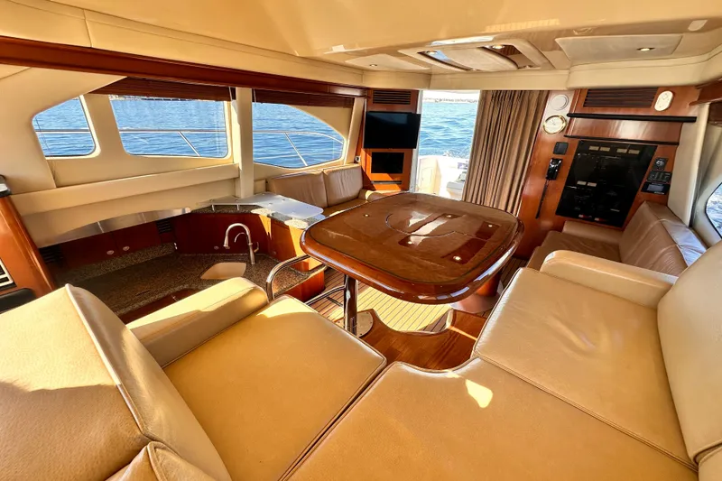 Slide: The Image of Luxurious interior of 2005 Sea Ray 420 Sedan Bridge yacht with elegant seating and ocean view. - 13
