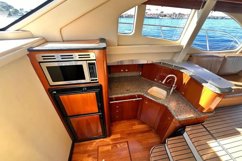 Slide: The Image of Luxurious 2005 Sea Ray 420 Sedan Bridge yacht interior with modern kitchen amenities. - 15
