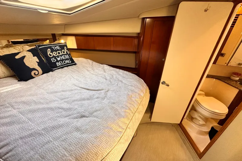 Slide: The Image of 2005 Sea Ray 420 Sedan Bridge cabin with cozy bed and private bathroom. - 17