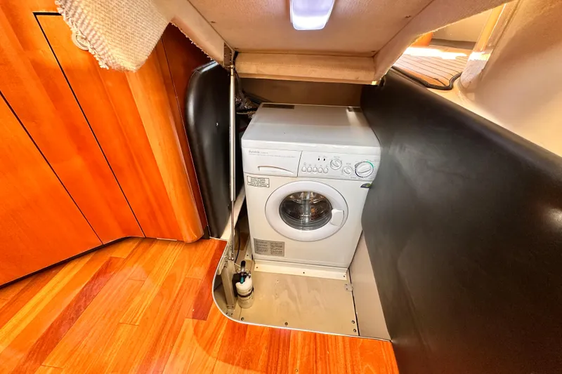 Slide: The Image of Washing machine in 2005 Sea Ray 420 Sedan Bridge yacht interior with wooden flooring. - 22