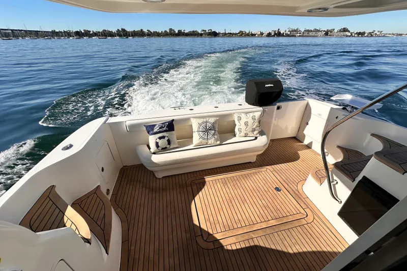 Slide: The Image of 2005 Sea Ray 420 Sedan Bridge yacht with teak deck, cruising on open water. - 5