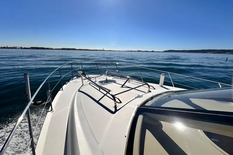 Slide: The Image of 2005 Sea Ray 420 Sedan Bridge cruising on calm waters under clear blue skies. - 7