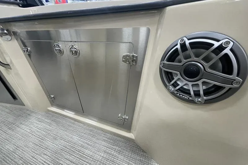 Slide: The Image of 2024 Sylvan G5 CLZ DC boat interior with stainless steel storage and speaker. - 12