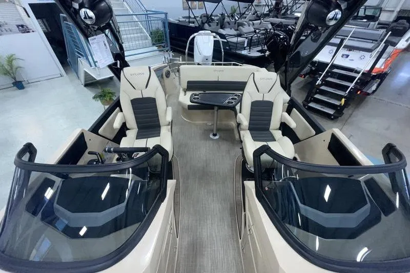 Slide: The Image of 2024 Sylvan G5 CLZ DC boat interior with seating and table, displayed in showroom. - 18