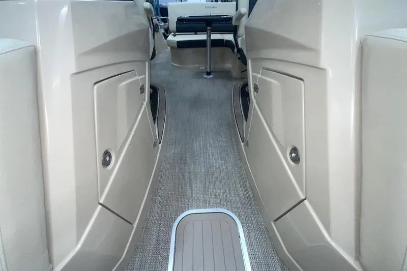 Slide: The Image of 2024 Sylvan G5 CLZ DC boat interior with beige seating and storage compartments. - 19