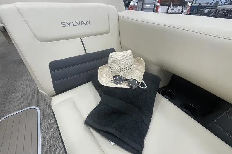 Slide: The Image of 2024 Sylvan G5 CLZ DC boat interior with hat, sunglasses, and towel on seat. - 21