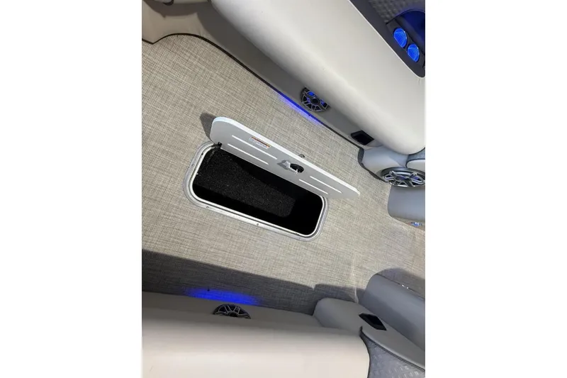 Slide: The Image of 2021 Premier 270 S-Series RF boat interior with open storage compartment and blue LED lighting. - 13