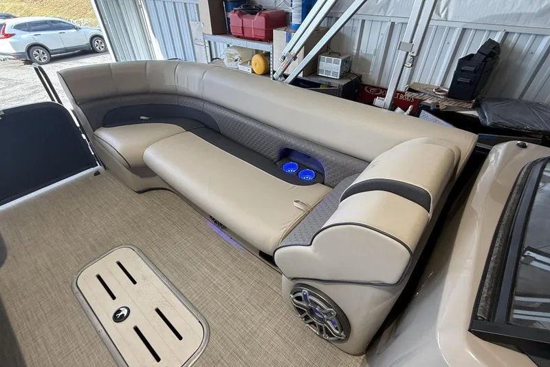 Slide: The Image of 2021 Premier 270 S-Series RF boat interior with beige seating and blue cup holders. - 17