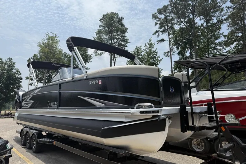 Slide: The Image of 2021 Premier 270 S-Series RF pontoon boat on trailer, surrounded by trees. - 24