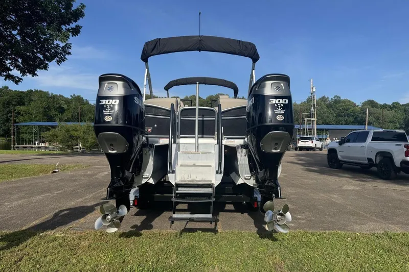 Slide: The Image of 2021 Premier 270 S-Series RF boat with dual Suzuki 300 engines, parked outdoors. - 25