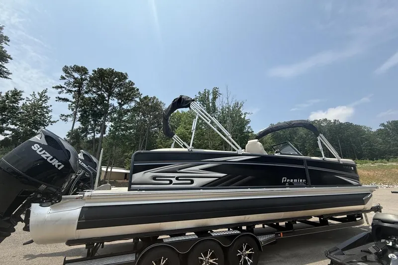 Slide: The Image of 2021 Premier 270 S-Series RF pontoon boat with Suzuki outboard motor on trailer. - 28