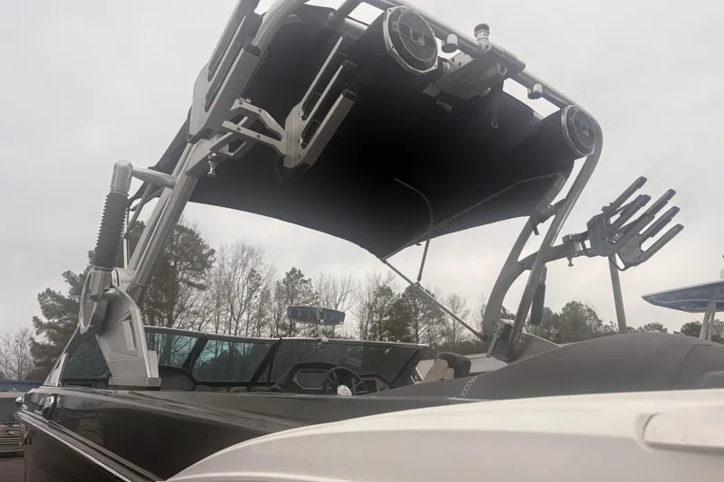 Slide: The Image of 2019 MasterCraft XStar boat with wakeboard tower and speakers, overcast sky background. - 15