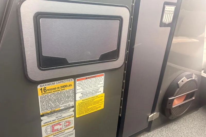 Slide: The Image of 2019 MasterCraft XStar boat capacity and safety labels on interior panel. - 21