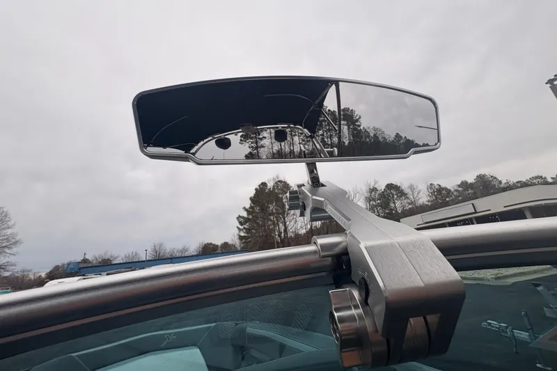 Slide: The Image of 2019 MasterCraft XStar boat mirror with overcast sky and trees in background. - 24