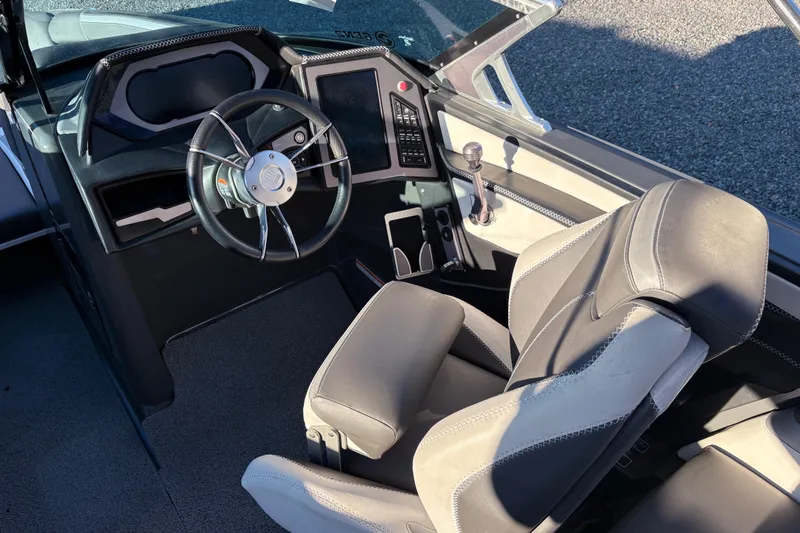 Slide: The Image of 2019 MasterCraft XStar boat interior with steering wheel and control panel. - 8