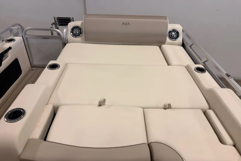 Slide: The Image of 2025 Avalon LSZ Versatile Rear Lounge boat interior with beige seating and cup holders. - 8