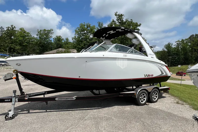 The Image of 2018 Cobalt R5 Surf boat on trailer, parked outdoors under a cloudy sky. - 0
