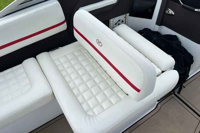 Slide: The Image of 2018 Cobalt R5 Surf boat interior with white quilted seating and red accents. - 15
