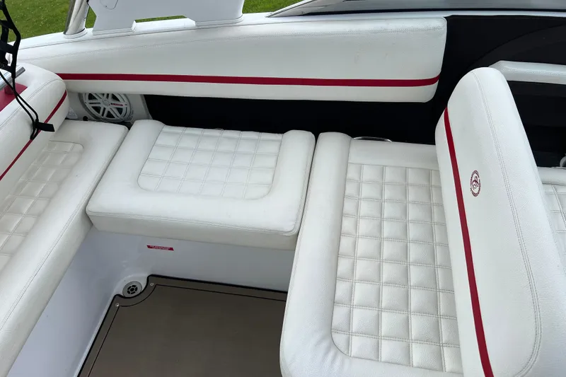 Slide: The Image of 2018 Cobalt R5 Surf boat interior with white quilted seats and red accents. - 16