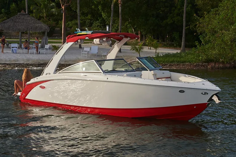 Slide: The Image of Manufacturer Provided Image: 2018 Cobalt R5 Surf boat with red and white design near a tropical beach. - 3
