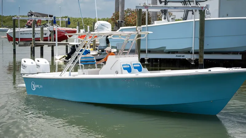 The Image of 2021 C-Hawk 29CC boat in marina, featuring twin engines and sleek blue design. - 0