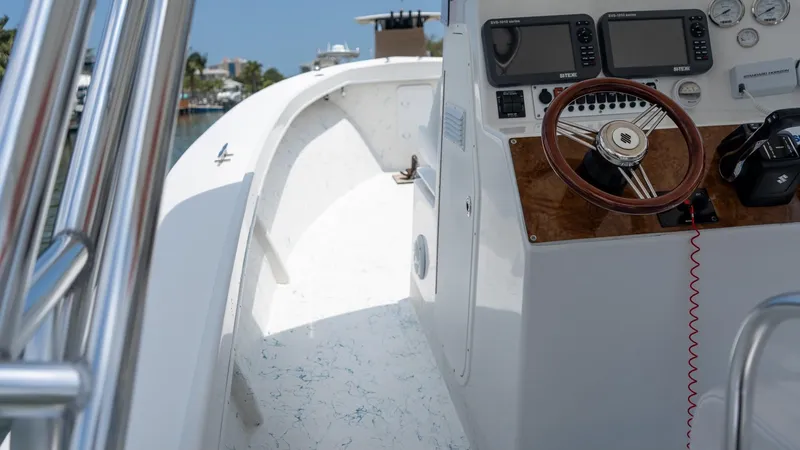 Slide: The Image of 2021 C-Hawk 29CC boat interior with steering wheel and navigation equipment. - 12