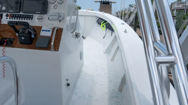 Slide: The Image of 2021 C-Hawk 29CC boat interior with control panel and railing. - 13