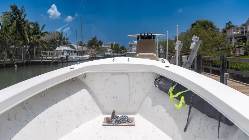 Slide: The Image of C-Hawk 29CC 2021 boat docked, sunny day, palm trees, and waterfront homes in the background. - 17