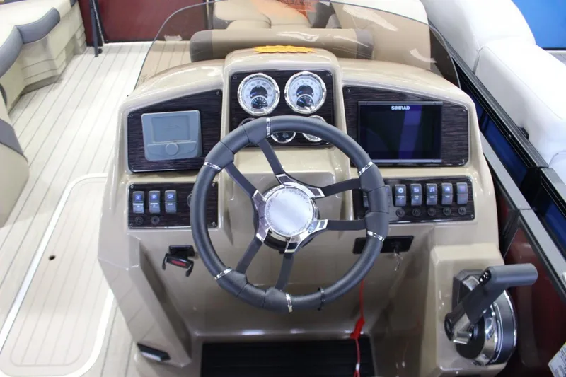 Slide: The Image of 2024 Sylvan Mirage X X3 boat dashboard with steering wheel and control panel. - 10