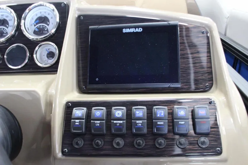 Slide: The Image of 2024 Sylvan Mirage X X3 dashboard with Simrad display and control switches. - 14