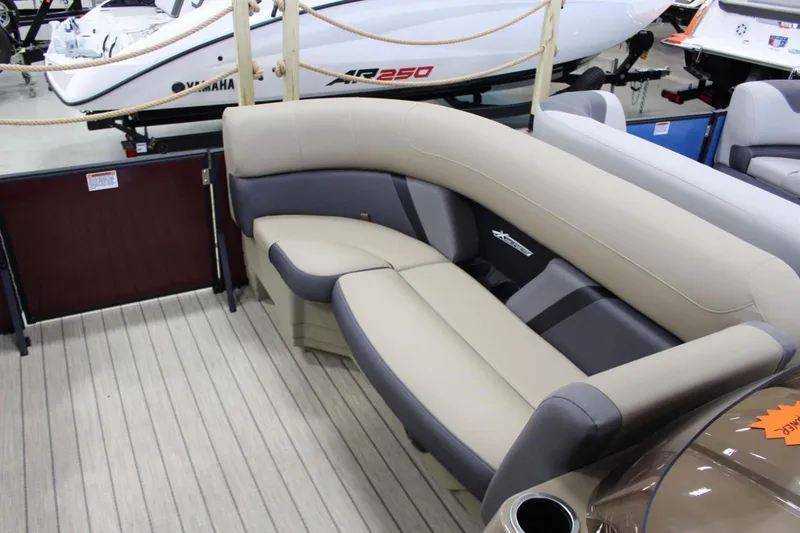 Slide: The Image of 2024 Sylvan Mirage X X3 pontoon boat interior with beige and gray seating. - 17