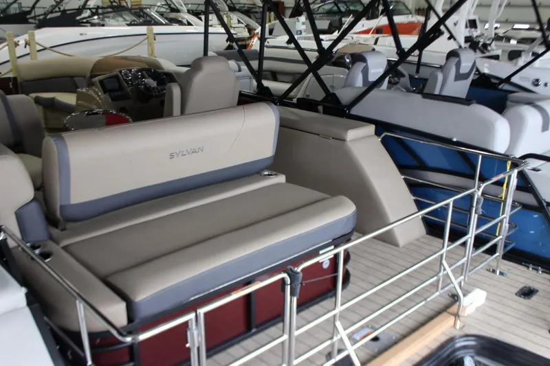 Slide: The Image of 2024 Sylvan Mirage X X3 pontoon boat interior with beige seating and modern design. - 4