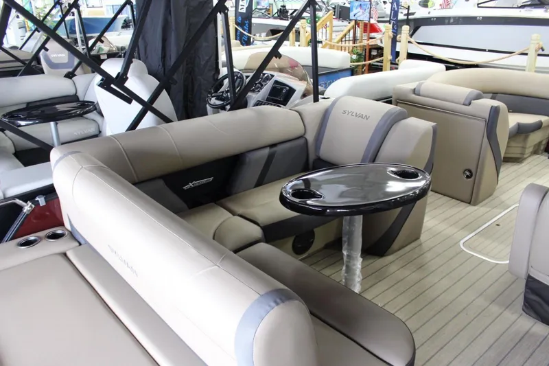 Slide: The Image of 2024 Sylvan Mirage X X3 pontoon boat interior with plush seating and sleek design. - 6