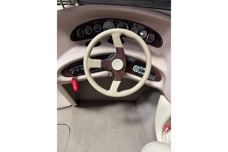 Slide: The Image of Steering wheel and dashboard of a 2000 Bryant 214 Walk Through boat. - 11