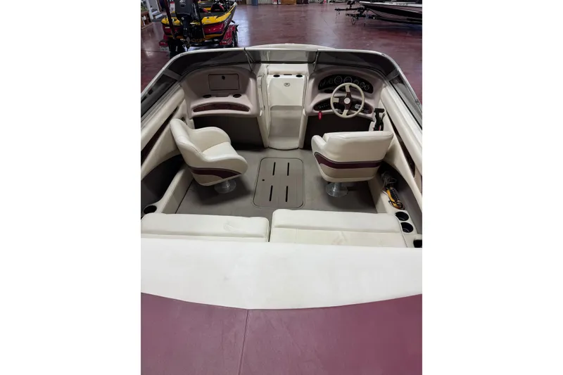 Slide: The Image of Interior of 2000 Bryant 214 Walk Through boat with seating and steering wheel. - 3