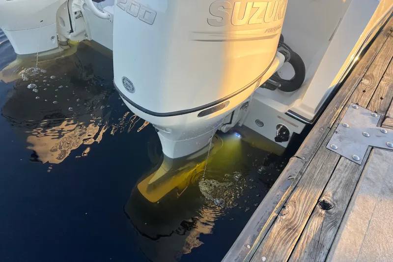 Slide: The Image of Outboard motor of 1997 Sea Cat SL5 Cat boat near wooden dock. - 19