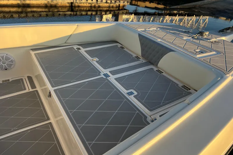 Slide: The Image of 1997 Sea Cat SL5 Cat boat interior with cushioned seating and storage compartments. - 21