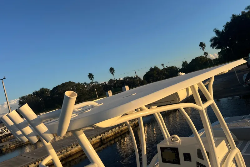 Slide: The Image of 1997 Sea Cat SL5 Cat boat docked at sunset, featuring a sleek white design. - 23