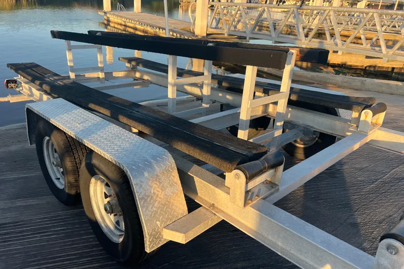 Slide: The Image of Boat trailer for 1997 Sea Cat SL5 Cat, parked near a dock. - 29