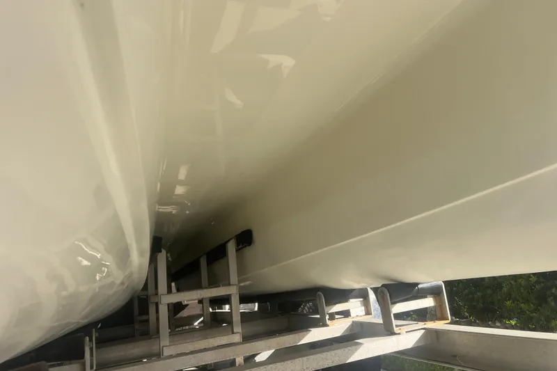 Slide: The Image of 1997 Sea Cat SL5 Cat boat hull on trailer, showcasing sleek design and structure. - 33