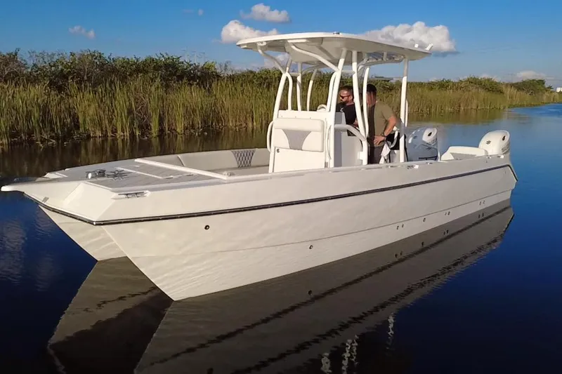 Slide: The Image of 1997 Sea Cat SL5 Cat boat on calm water, featuring sleek design and dual engines. - 8