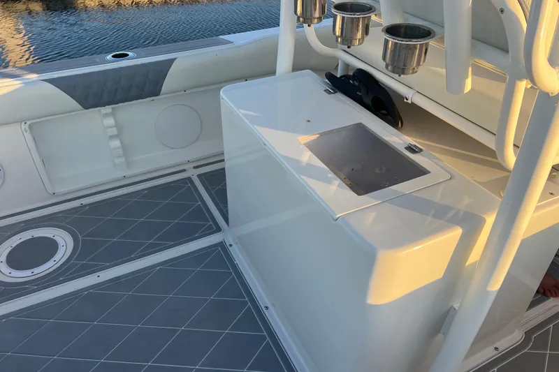 Slide: The Image of 1997 Sea Cat SL5 Cat boat interior with rod holders and storage compartments. - 17
